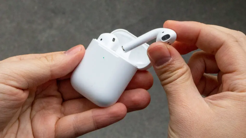 Why Are My AirPods So Quiet - A hand removing an AirPod from the case.
